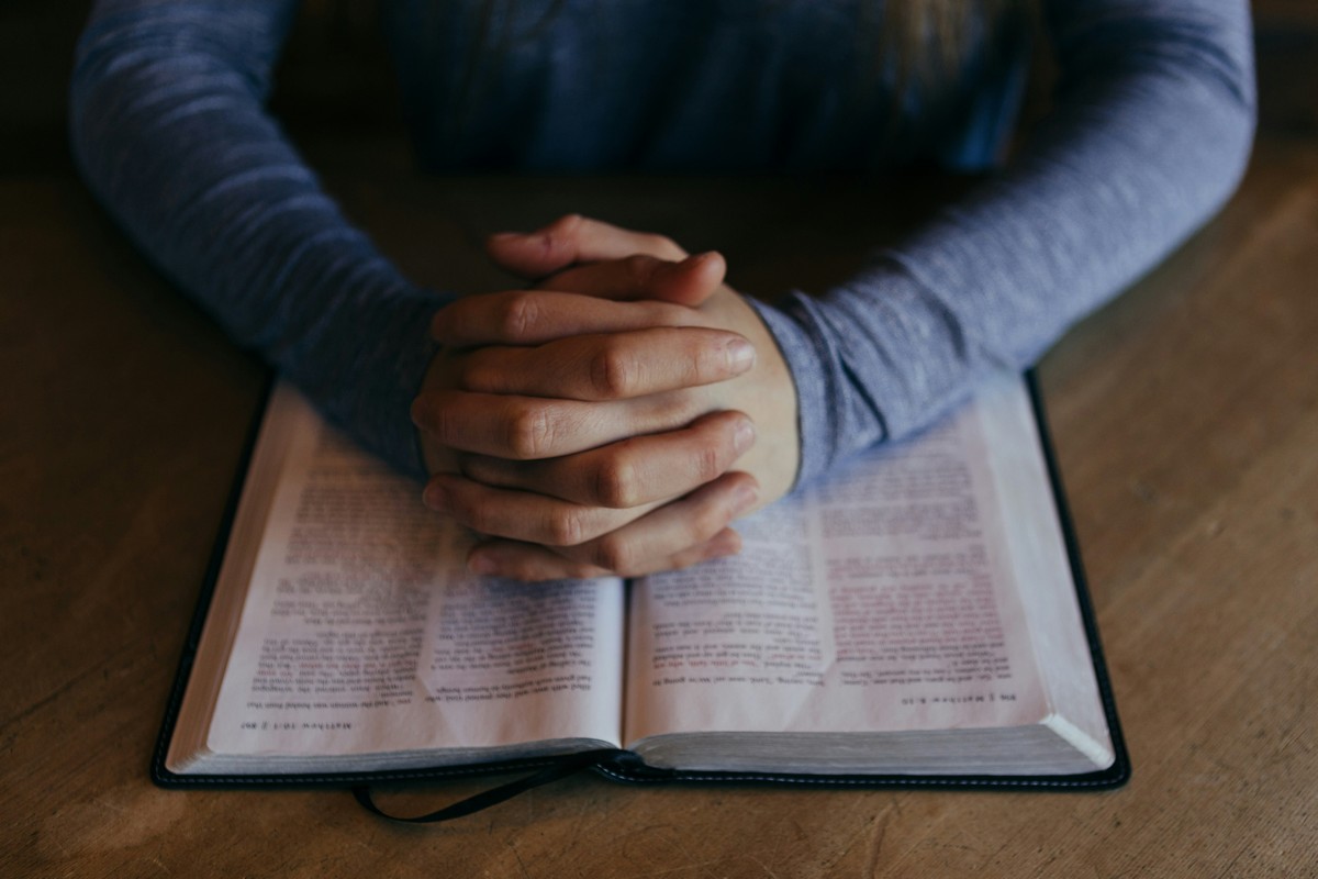 Prayer hands with Bible